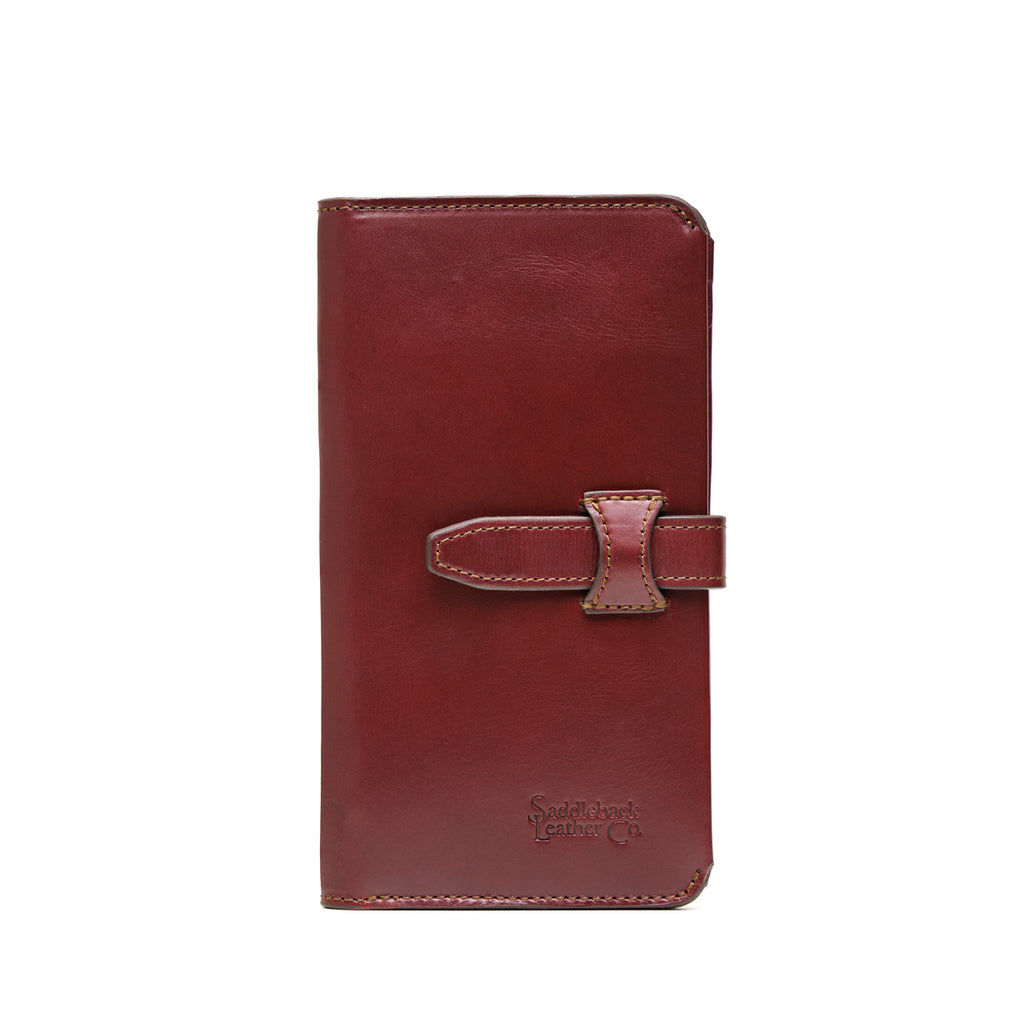 Big Wallet in Oxblood, closed front view with strap closure and debossed Saddleback Leather Co. logo