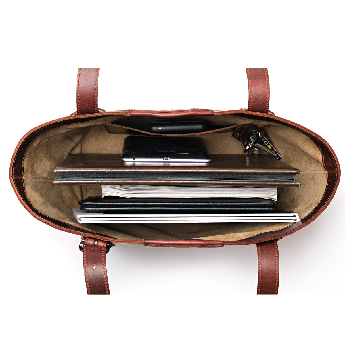 Original Tote in Chestnut, top-down view packed with a laptop, notebooks, folders and keys