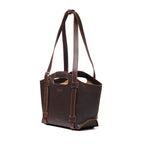 Original Tote in Dark Coffee Brown, angled front view with cutout handle and buckled shoulder straps