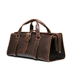 Leather Range and Tool Bag in Dark Coffee Brown, angled front view with top handles, buckle strap and side frame opening
