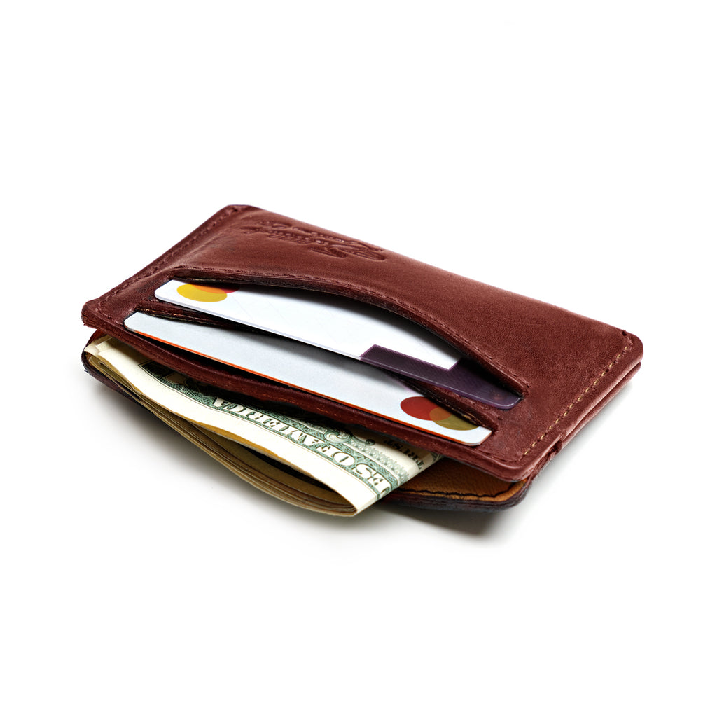 Newton Wallet in Oxblood loaded with cards in the slots and folded cash in the center pocket