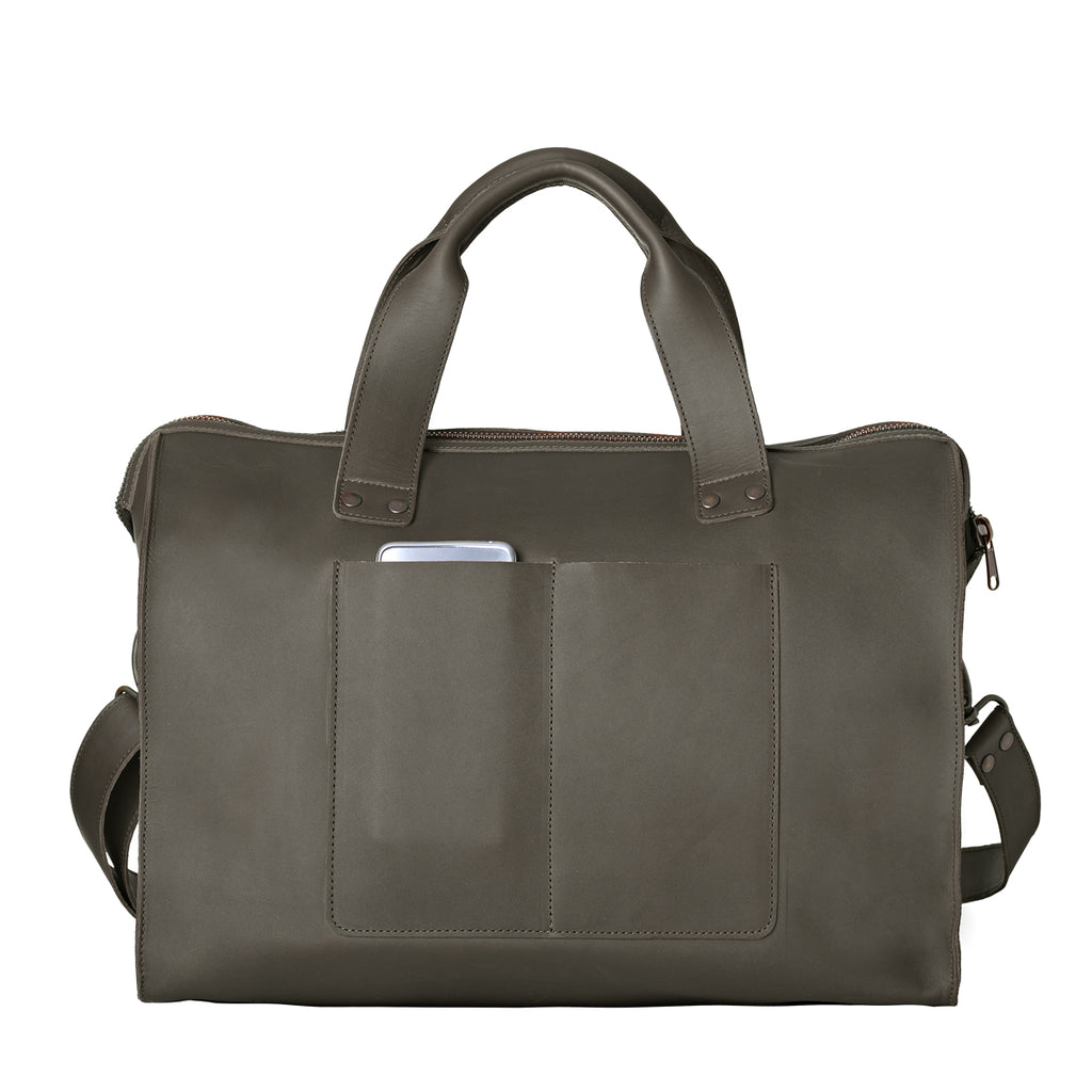 Simple Overnight Leather Duffle Bag in Black, back view with exterior slip pockets holding a phone