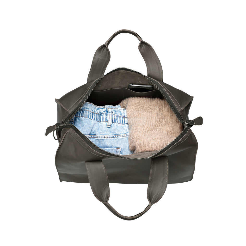 Simple Overnight Leather Duffle Bag in Black, open top packed with folded jeans and a sweater