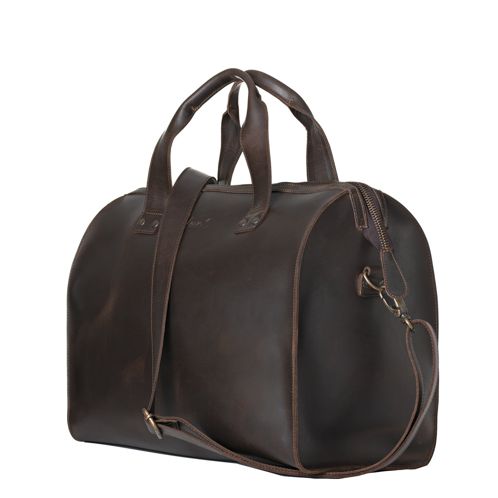 Simple Overnight Leather Duffle Bag in Dark Coffee Brown, angled side view with shoulder strap clipped on