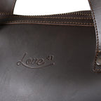 Simple Overnight Leather Duffle Bag in Dark Coffee Brown, close-up of the embossed Love 41 logo and riveted handle