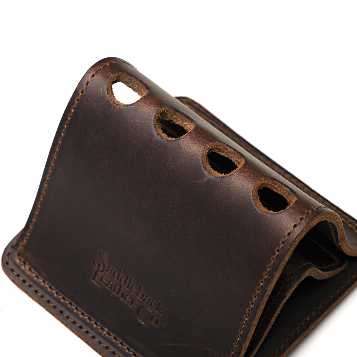 Pen Holder Bell Curve in Dark Coffee Brown leather, close-up angled view of the four pen holes and embossed logo