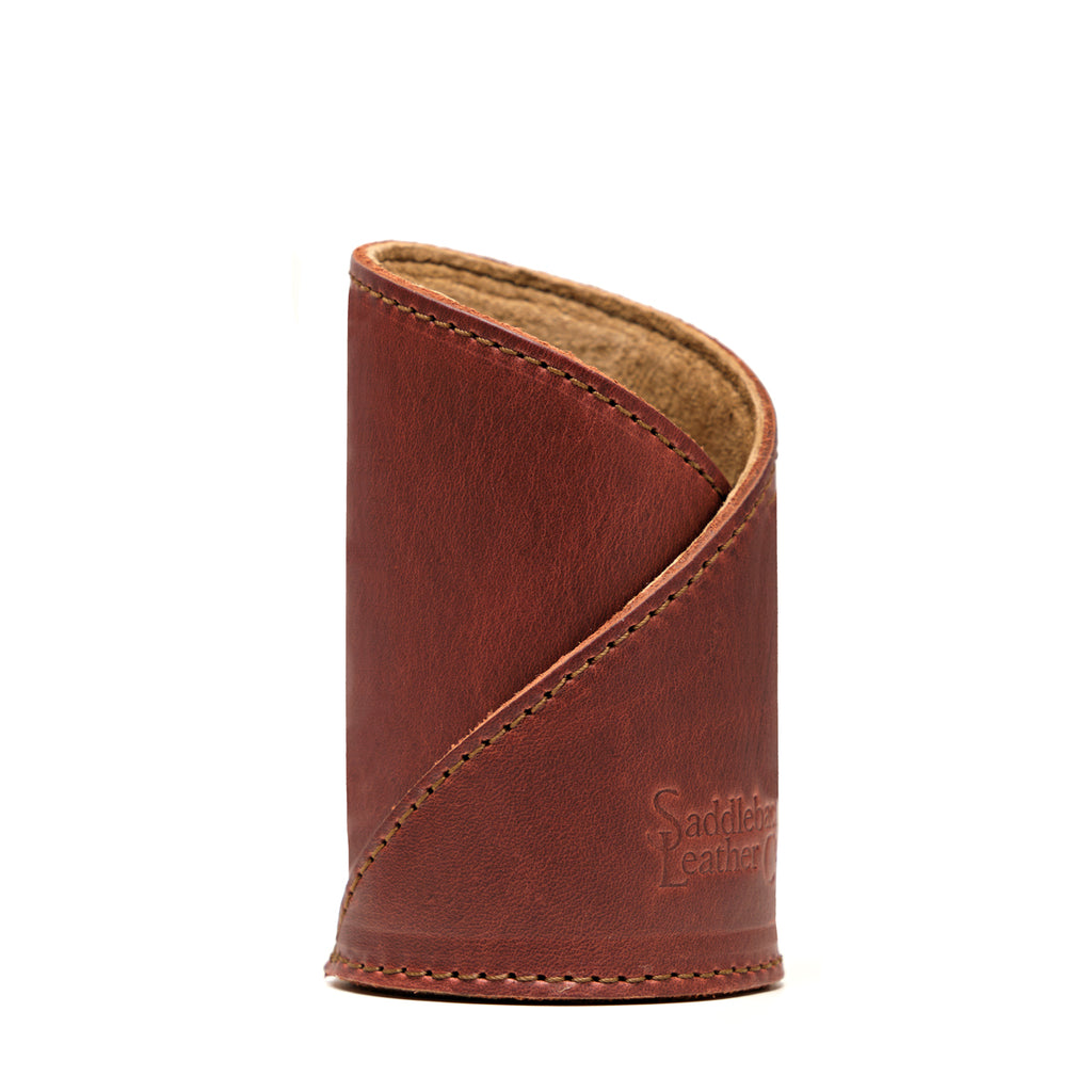 Pen Cup in Chestnut leather, front view of the empty cup with diagonal stitched wrap and embossed logo