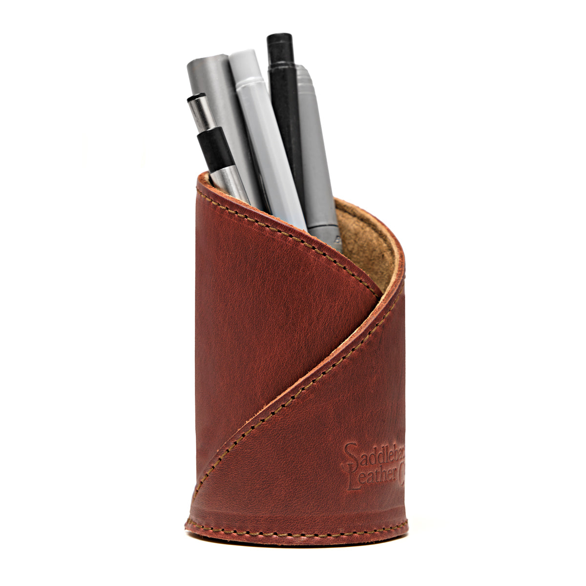Pen Cup in Chestnut leather, front view showing the diagonal stitched wrap and embossed logo, holding pens