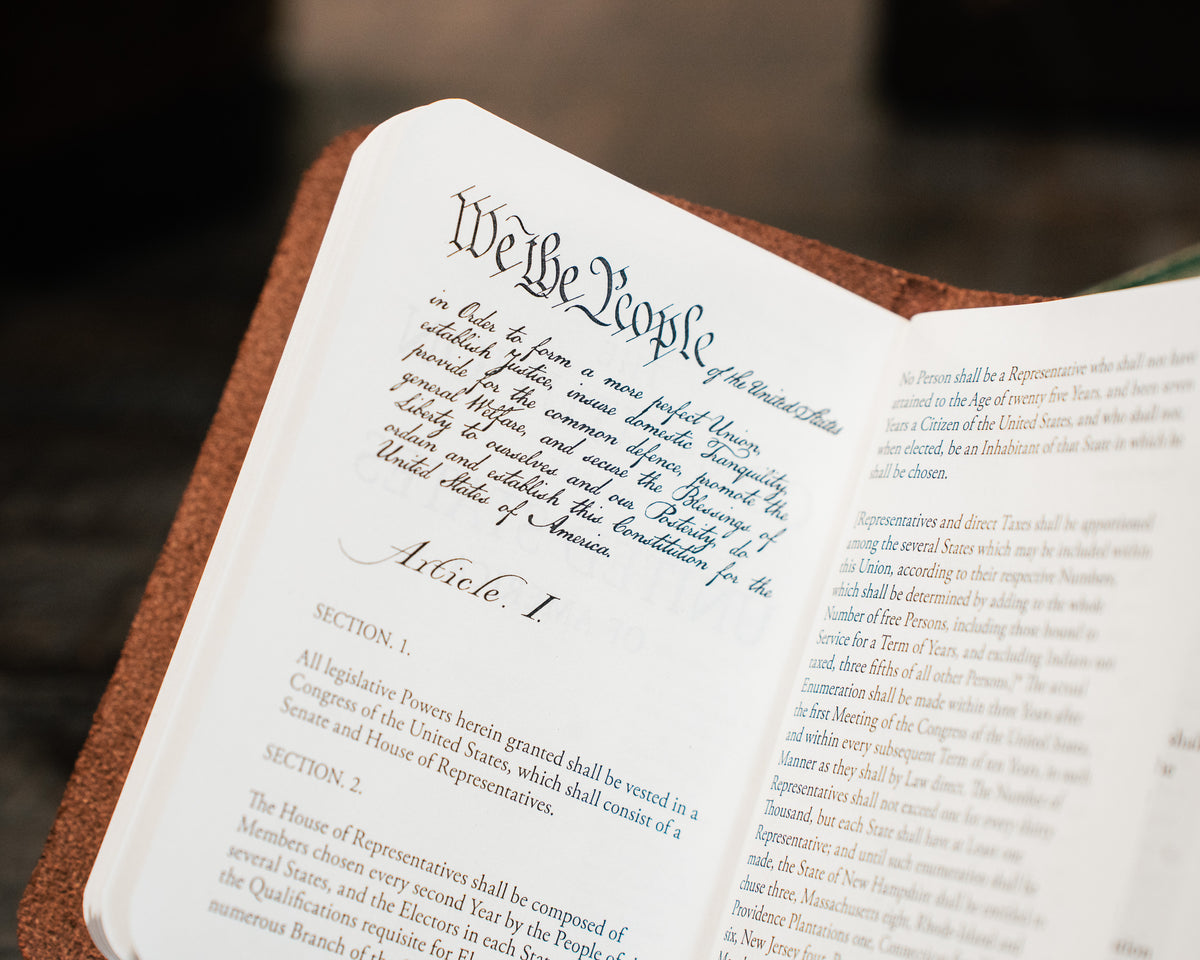 Pocket Declaration/Constitution opened to the We the People preamble and Article I, close-up