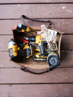 Range and Tool Tote open on a wooden deck, filled with cordless power tools, screwdrivers and work gloves