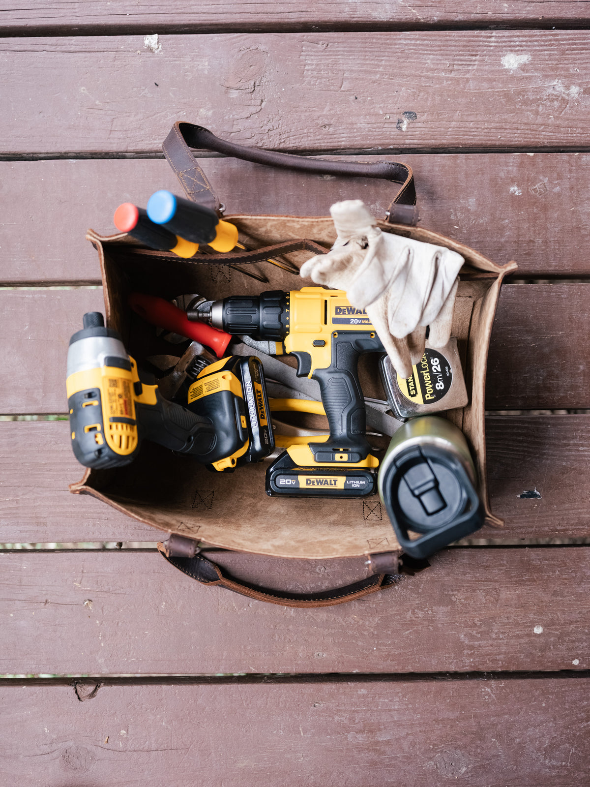 Range and Tool Tote open on a wooden deck, filled with cordless power tools, screwdrivers and work gloves
