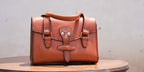 Double Handle Purse in English Tan on a round wooden table against a light gray wall