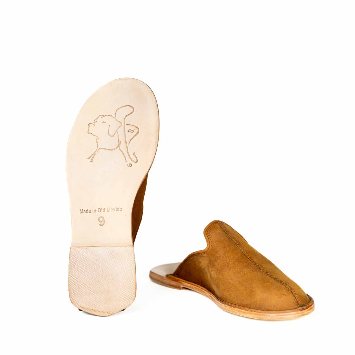 Barefoot Slip-on Mule in Tobacco beside a leather sole showing the embossed bulldog logo and size stamp