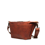 London Sling Large in Chestnut, angled side view showing the front pocket and strap clip