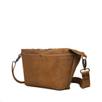 London Sling Large in Tobacco, angled side view showing the front pocket and strap clip