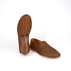 Barefoot Slip-on Shoes in Tobacco, one standing on its heel and one in side profile