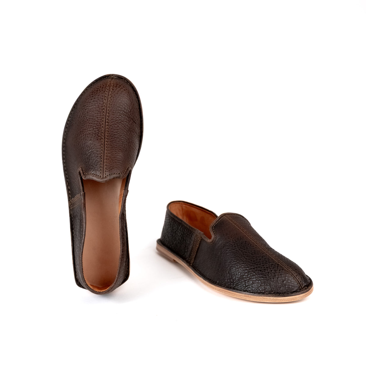 Barefoot Slip-on Shoes in Dark Coffee Brown, one standing on its heel and one in side profile