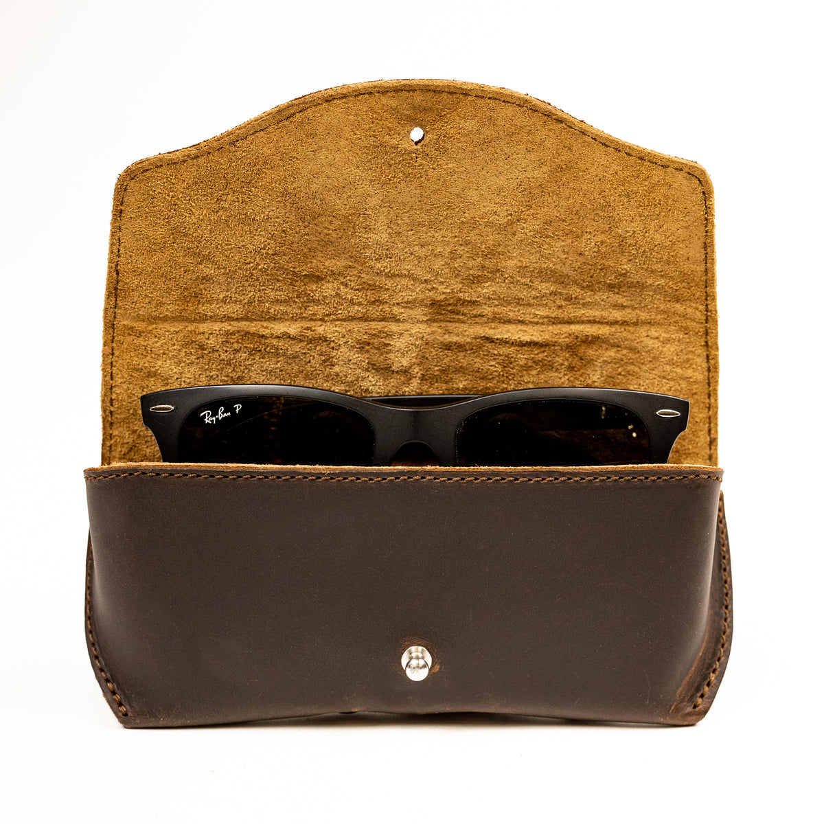 Leather Sunglass Case in Dark Coffee Brown, flap open to show suede lining with a pair of sunglasses inside