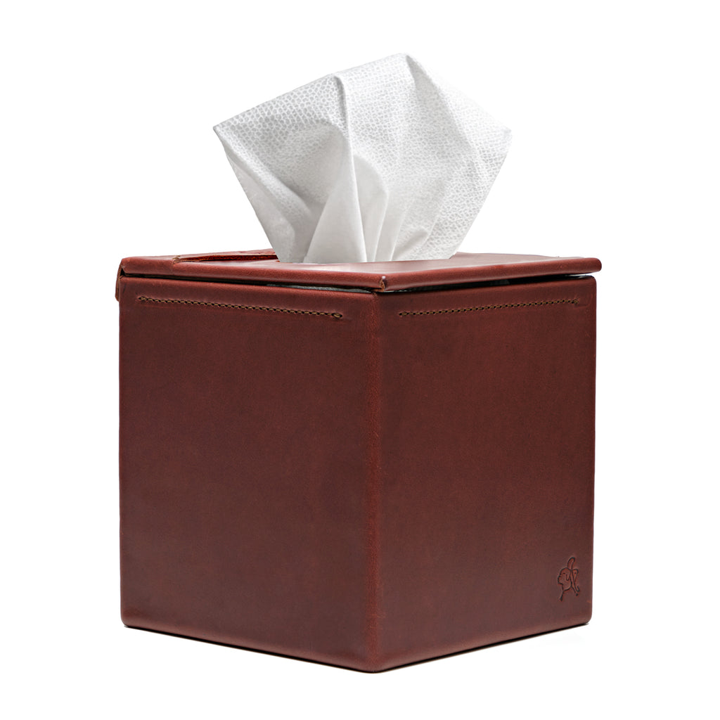 Tissue Box in Chestnut leather, front view with stitched seams and a tissue pulled from the top