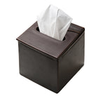 Tissue Box in Dark Coffee Brown leather, top angled view with a tissue pulled through the slot