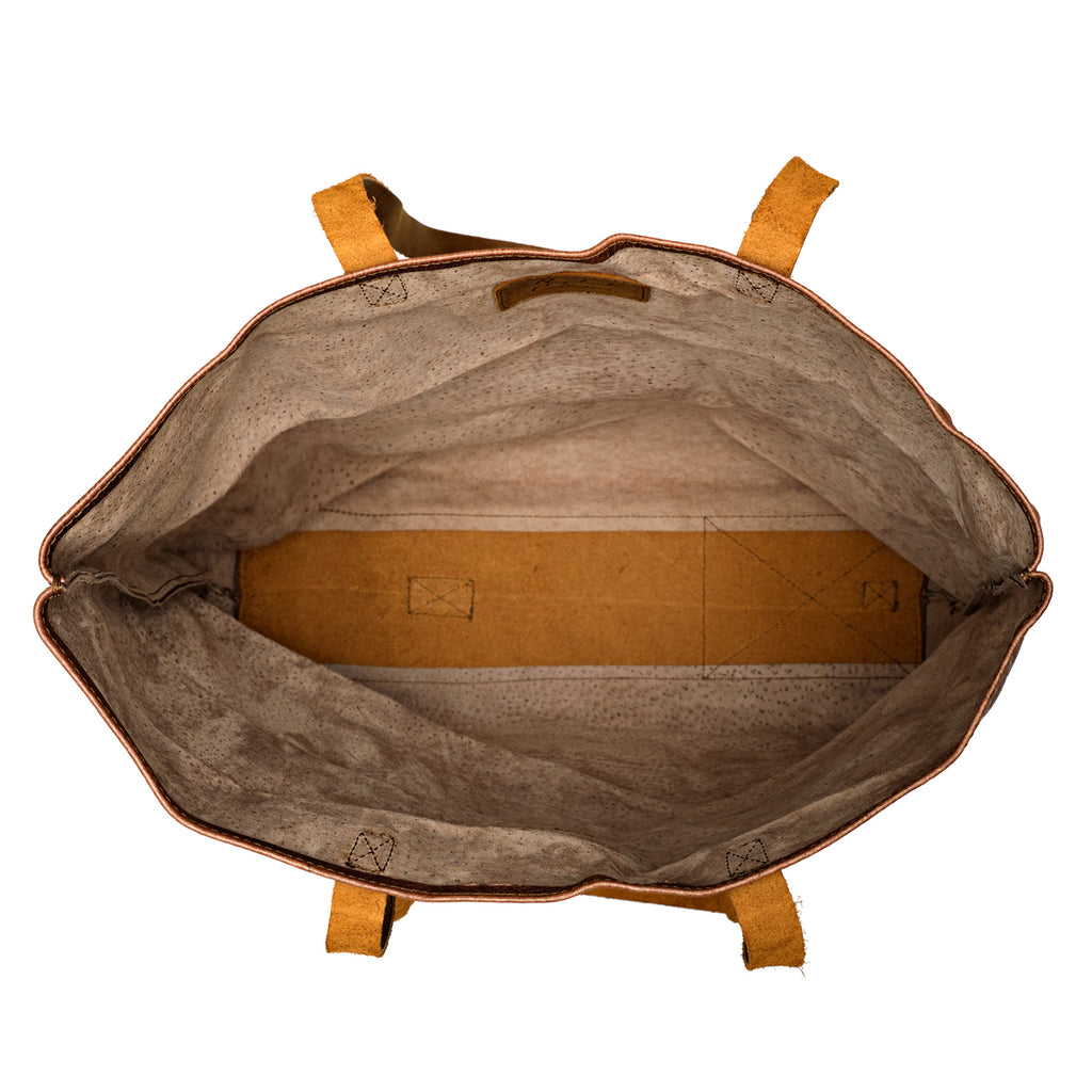 Travel Tote in Burnt Sausage, top view open and empty showing the roomy interior and leather base panel