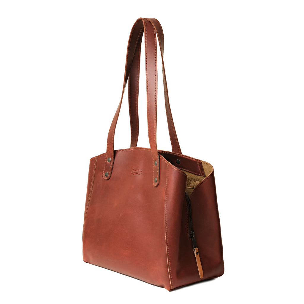Leather Organizer Satchel in Chestnut, angled side view showing the side zipper pull