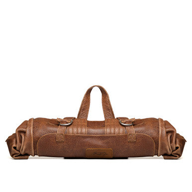 Large Travel Backpack in Burnt Sausage, rolled up and carried by top handle