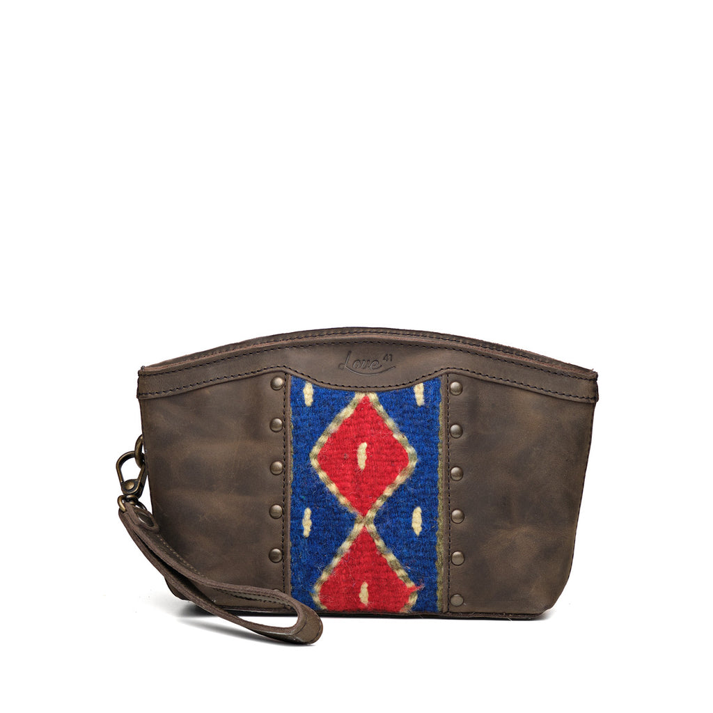 Lanita Leather Clutch in charcoal gray, front view with blue and red woven panel, studs and wrist strap