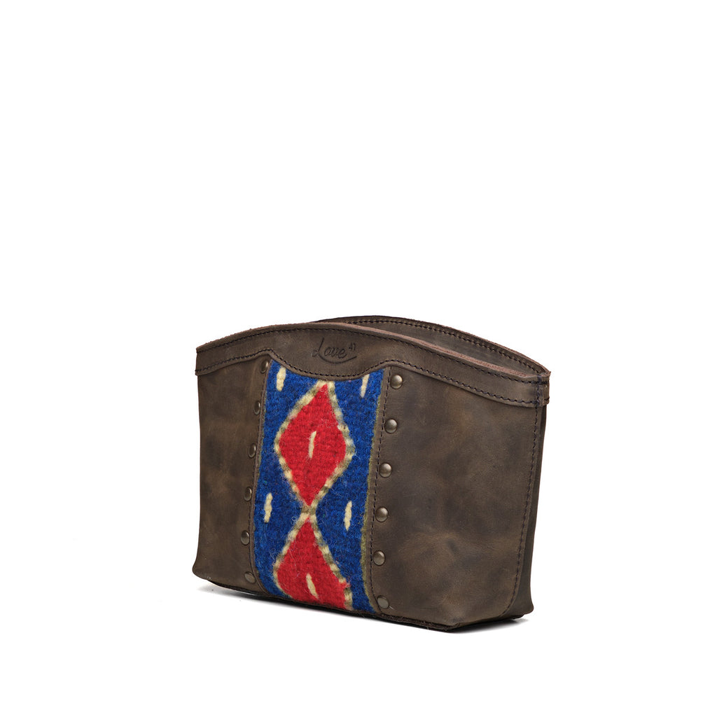 Lanita Leather Clutch in charcoal gray, angled front view with woven panel and studs