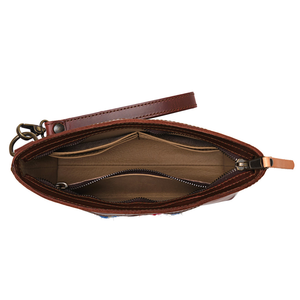 Lanita Leather Clutch in Chestnut, top-down view of empty unzipped interior with wrist strap
