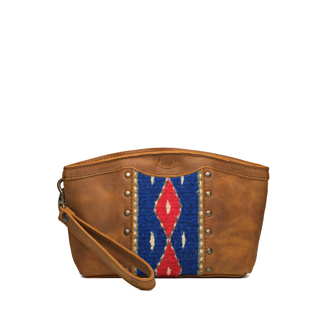 Lanita Leather Clutch in Tobacco, front view with blue and red woven panel, studs and wrist strap