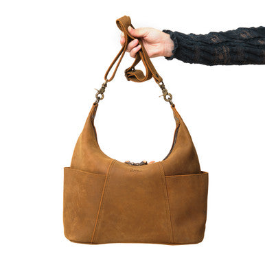 Hand holding the Women's Hobo Organizer Bag in Tobacco by its strap, front view