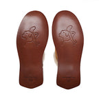 Women's Sheepskin Slippers in Tobacco, bottom view of the stamped leather soles