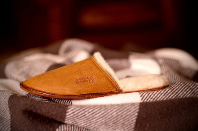 Women's Sheepskin Slipper in Tobacco on a plaid blanket