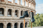 Pair of high quality black leather Officer Boots on stands in front of the Colosseum in Rome