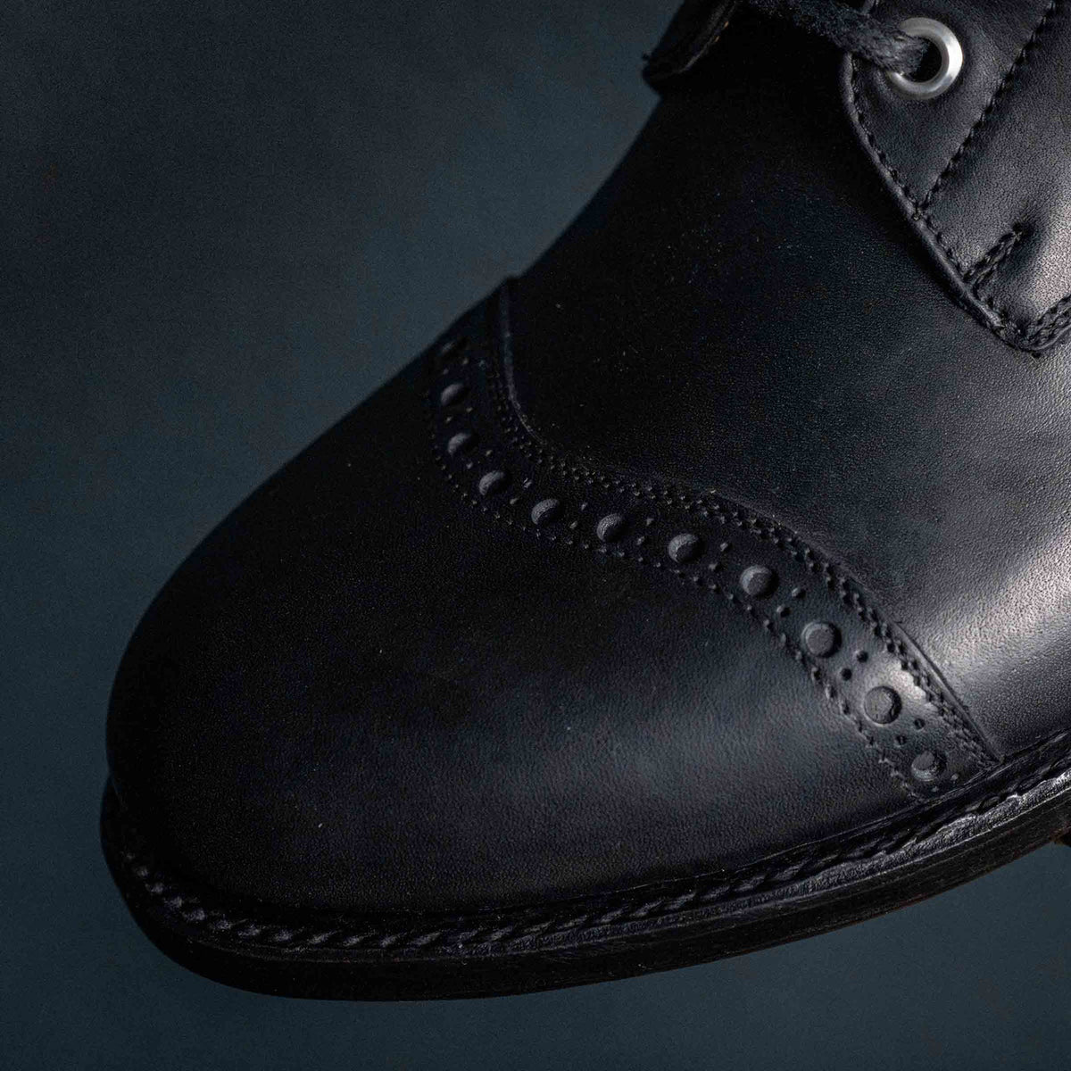 Close detail of the brogued toe cap on a high quality black leather Officer Boot