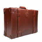 Grandfather Medium Suitcase in Chestnut, angled back view with top handle, straps and riveted corners