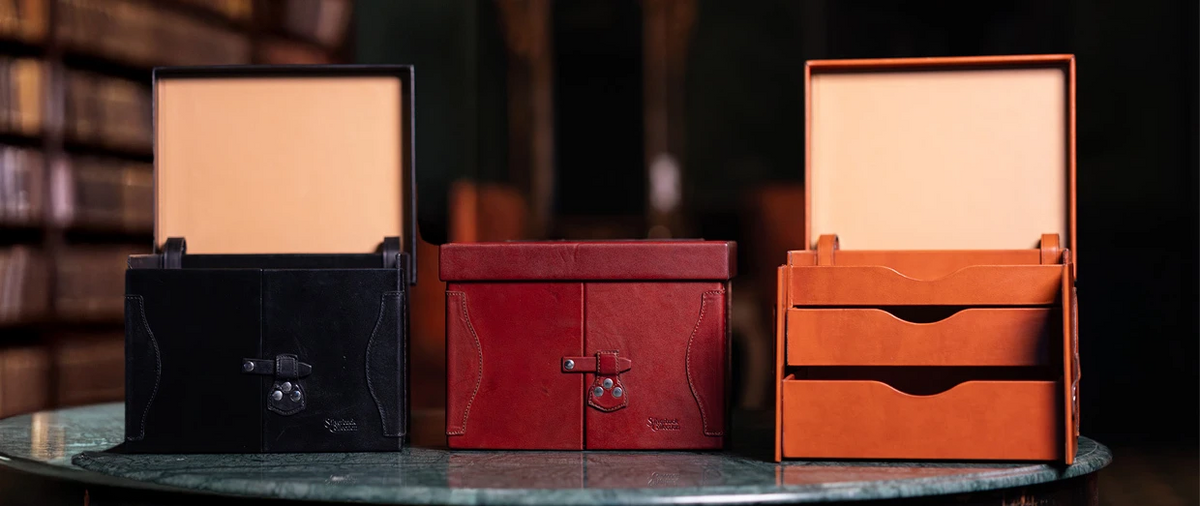 Silverback Churchill Case in Black, Oxblood and Natural on a marble table, two with lids open