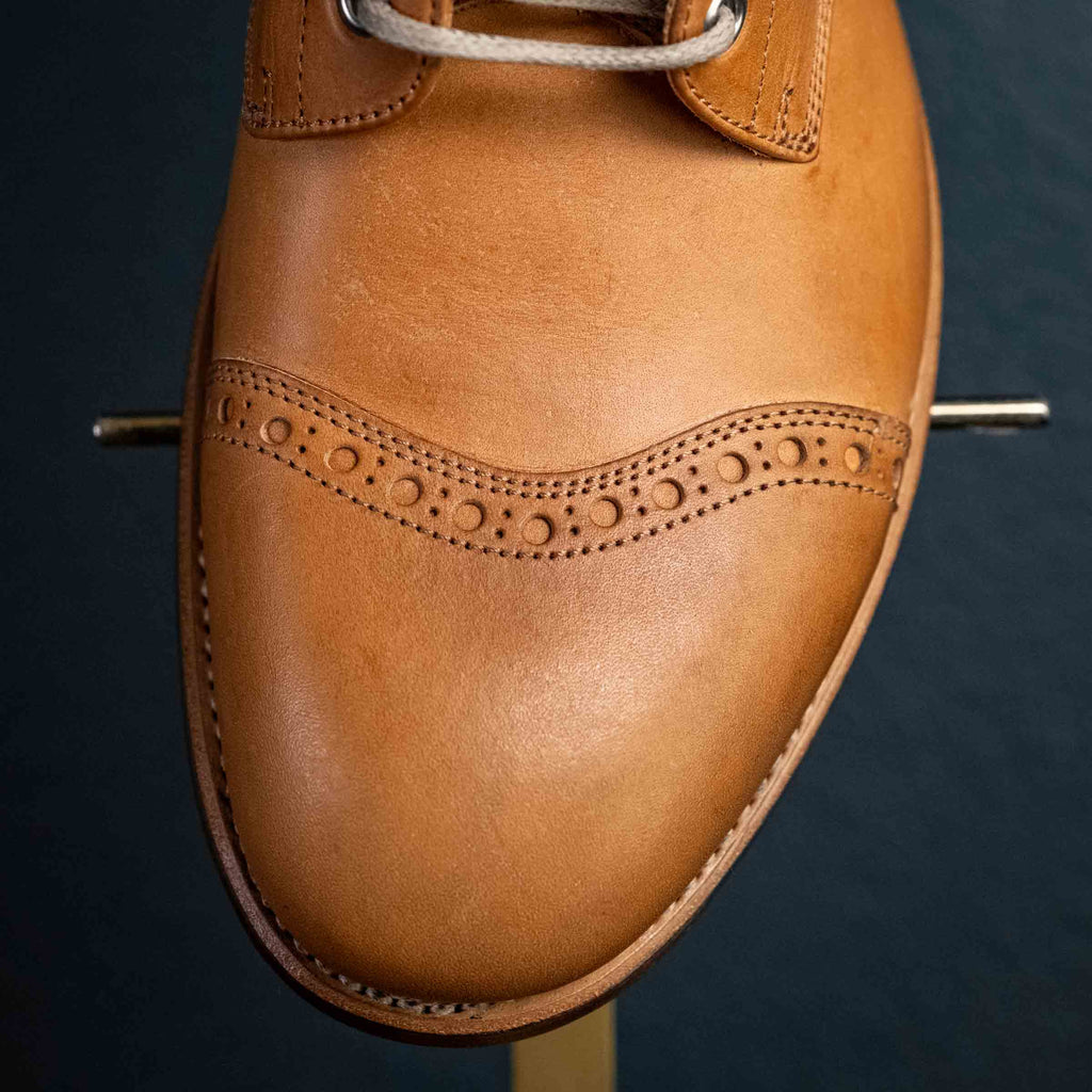 Officer's Boot in English Tan, close-up of the brogued cap toe from above