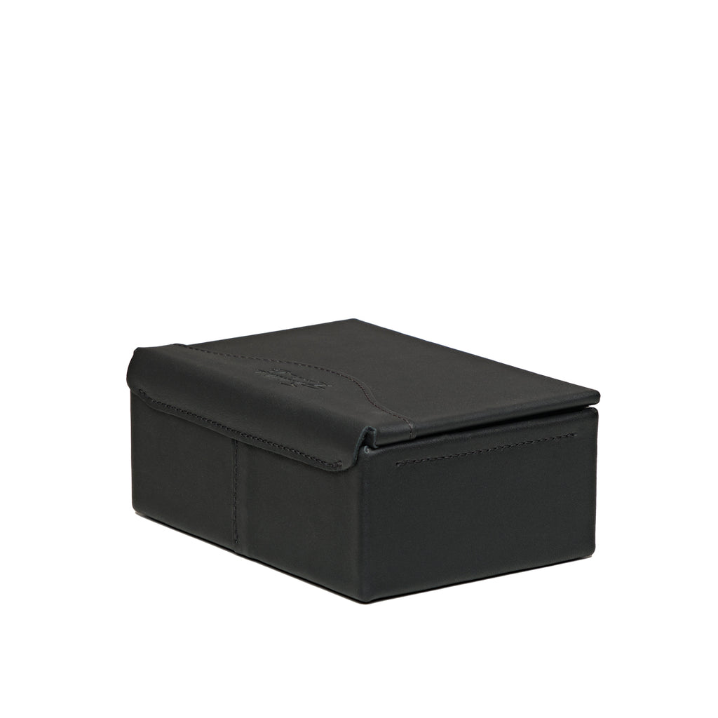 Small Organizer Box in Black, closed, angled back view showing the lid hinge and stitched seams