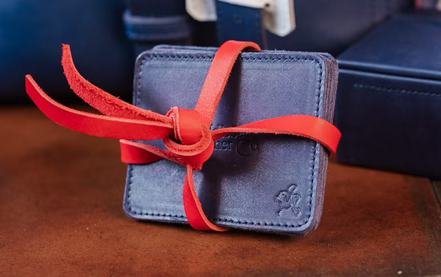 The navy leather coaster set tied together with a red leather strap