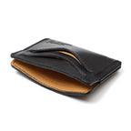 Newton Wallet in Raven Black, angled side view showing the tan interior and curved card slots