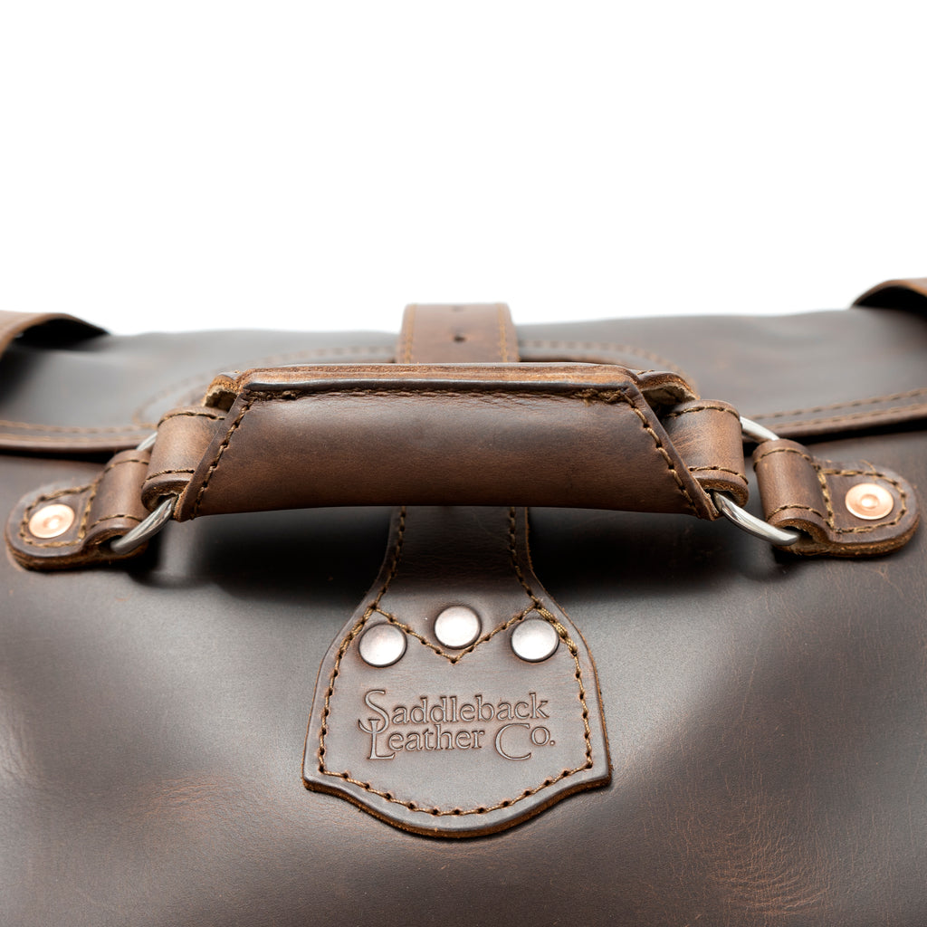20" Waterbag in Dark Coffee Brown, close-up of top handle and riveted Saddleback Leather Co. tab