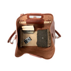 20" Waterbag in Chestnut, open top-down view of interior with books, camera and a sweater