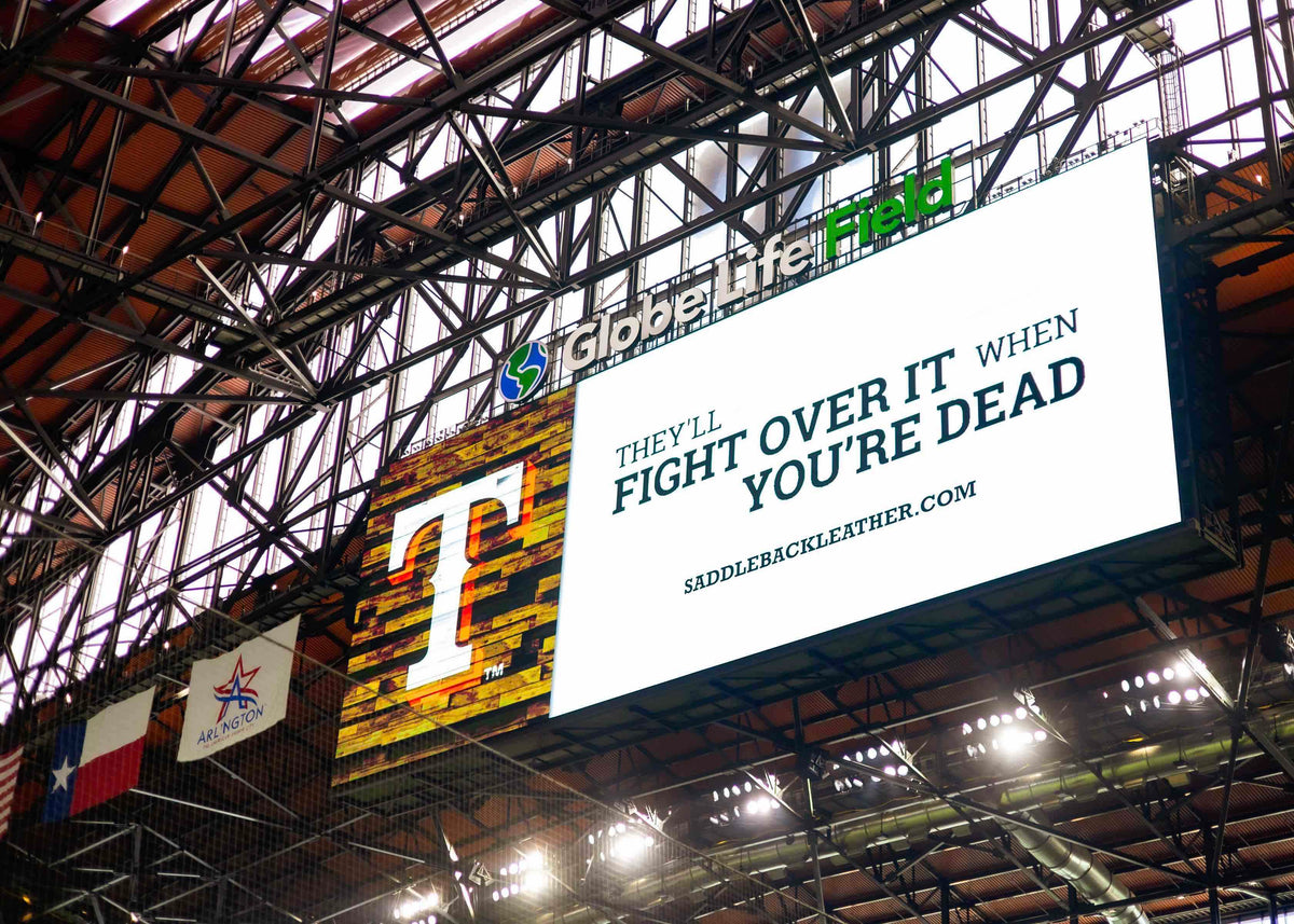 The Globe Life Field scoreboard showing the Texas Rangers T and the Saddleback slogan: They'll fight over it when you're dead.