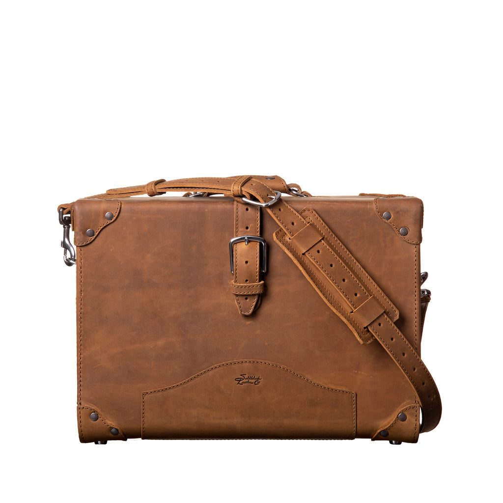 Grandfather Overnight Case in Tobacco, front view with buckled strap and shoulder strap attached