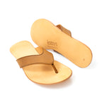 Flip Flops in Tobacco leather, one upright and one flipped to show the logo-embossed sole