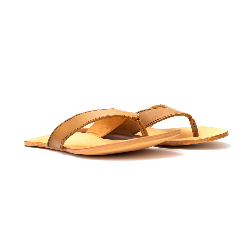 Pair of Flip Flops in Tobacco leather with natural footbeds, low side angle view