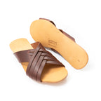 Martha Sandals in Chestnut, pair with one sandal flipped to show the sole and stamped logo