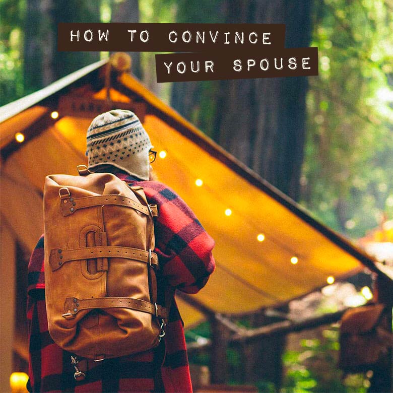 How to Convince Your Spouse: a man in a red plaid jacket and a knitted hat, a tan leather backpack on his back, faces a canvas tent strung with lights in a forest.
